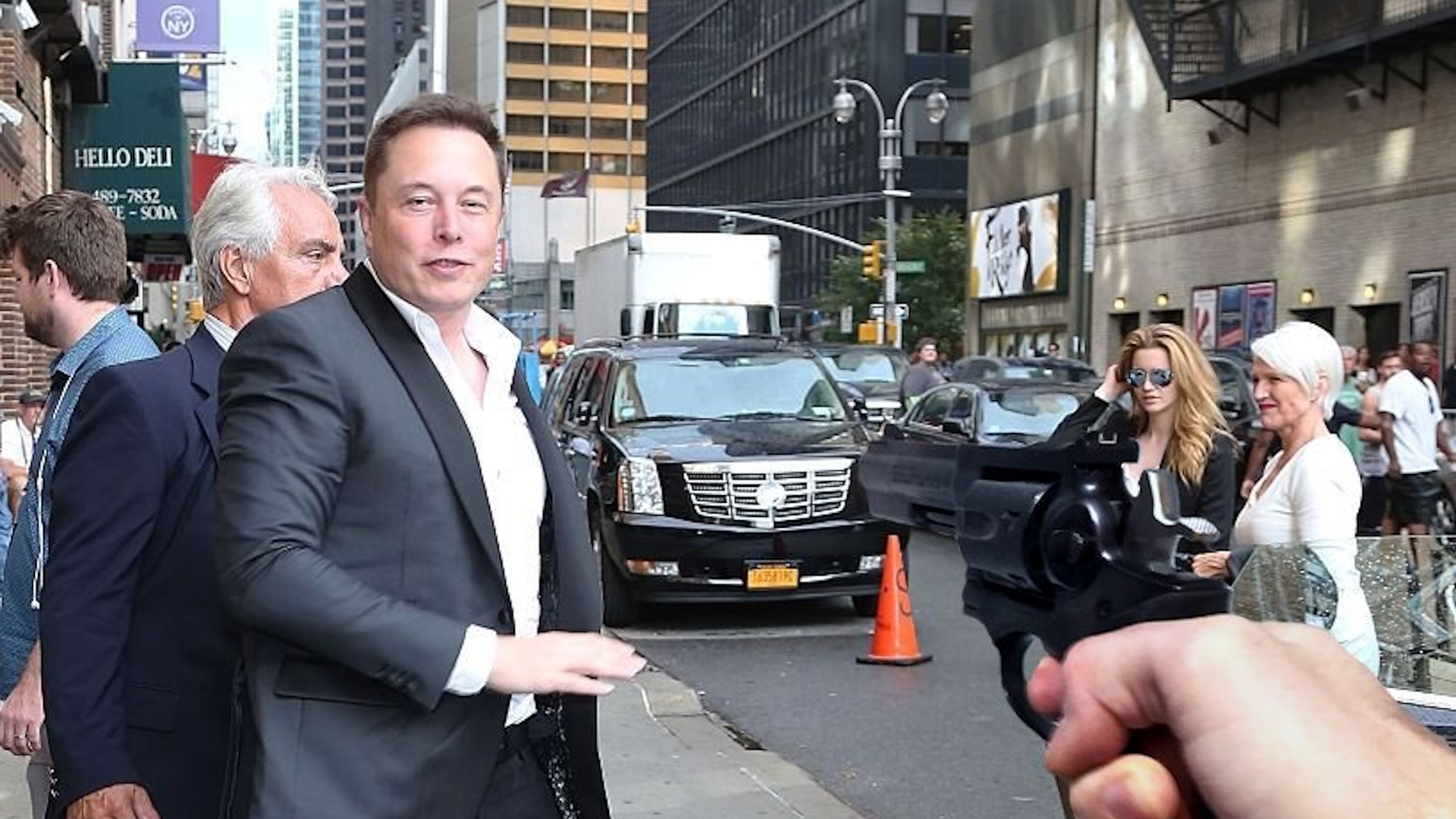 Guy Pointing a Gun at Elon Musk