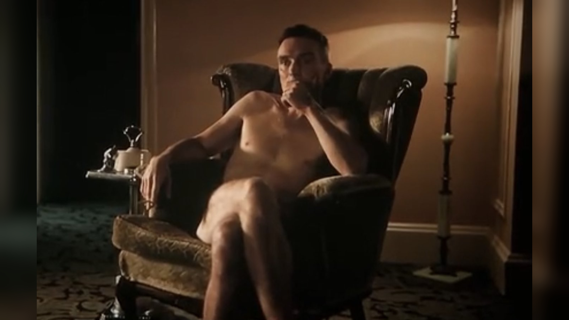 Naked Oppenheimer in a Chair