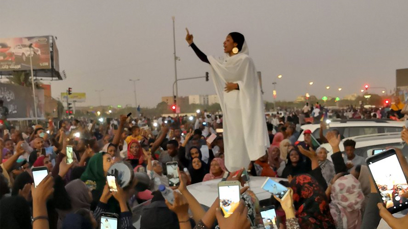 Protesting Sudanese Woman Standing on Car